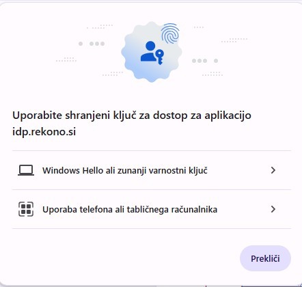 Prikaz okna za prijavo z uporabo shranjenega ključa za dostop do aplikacije idp.rekono.si. Možnosti vključujejo prijavo prek sistema Windows Hello ali zunanjega varnostnega ključa ter uporabo telefona ali tabličnega računalnika. Na dnu je gumb »Prekliči«.